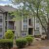 exterior of a building with many windows next to trees and bushes