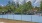 a tennis court with a fence and trees around it