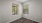 a room with a wood floor and a window with a tree outside